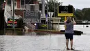 Seorang warga mengambil gambar meningkatnya air banjir akibat hujan deras di pinggiran barat daya Camden, Sydney, Australia, Selasa (8/3/2022). (Muhammad FAROOQ/AFP)