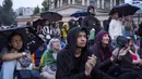 Penonton yang berjumlah sekitar 300.000 orang menyaksikan langsung dari tribun yang dibangun khusus di tepi sungai, sementara 200.000 lainnya menyaksikan dari balkon dan apartemen yang menghadap ke sungai. (AP Photo/Louise Delmotte)