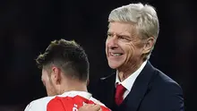 Senyum bahagia pelatih Arsenal, Arsene Wenger, setelah Mesut Ozil mencetak gol kedua ke gawang Munchen. (EPA/Andy Rain)