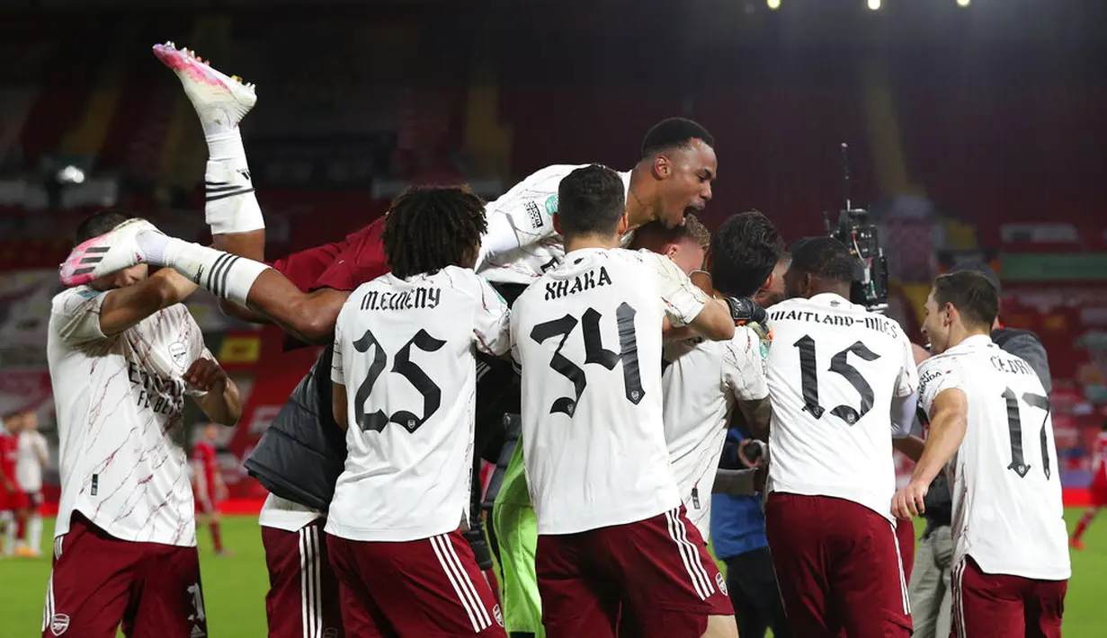 Para pemain Arsenal melakukan selebrasi usai memenangi pertandingan babak keempat Piala Liga antara Liverpool dan Arsenal di Anfield, Liverpool, Inggris, Kamis (1/10/2020). Arsenal mengalahkan Liverpool 5-4 dalam adu penalti. (Peter Byrne/Pool via AP)