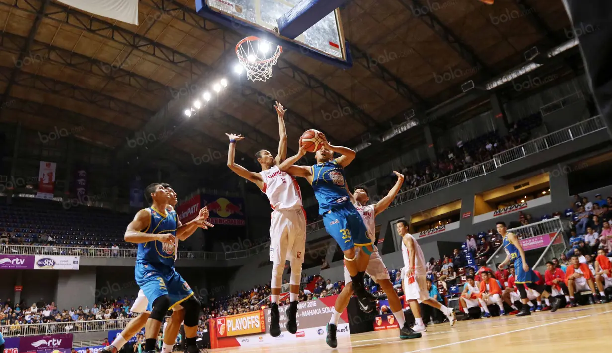Pemain Satria Muda, Wisnu Arki #32  mencoba melepaskan tembakan saat dihadang pemain Garuda Bandung pada  perempat final Playoffs Indonesia  Basket League (IBL) di Britama Arena, Jakarta, Selasa (17/5/2016). (Bola.com/Nicklas Hanoatubun)