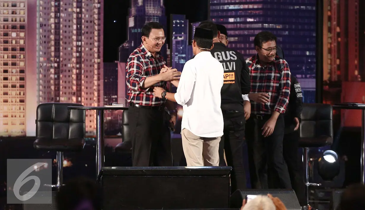 Cagub nomor 2, Basuki T Purnama (kiri) bersalaman dengan Cawagub nomor 3, Sandiaga Uno (kemeja putih) usai debat perdana Cagub DKI-Jakarta, Jumat (13/1). (Liputan6.com/Faizal Fanani)