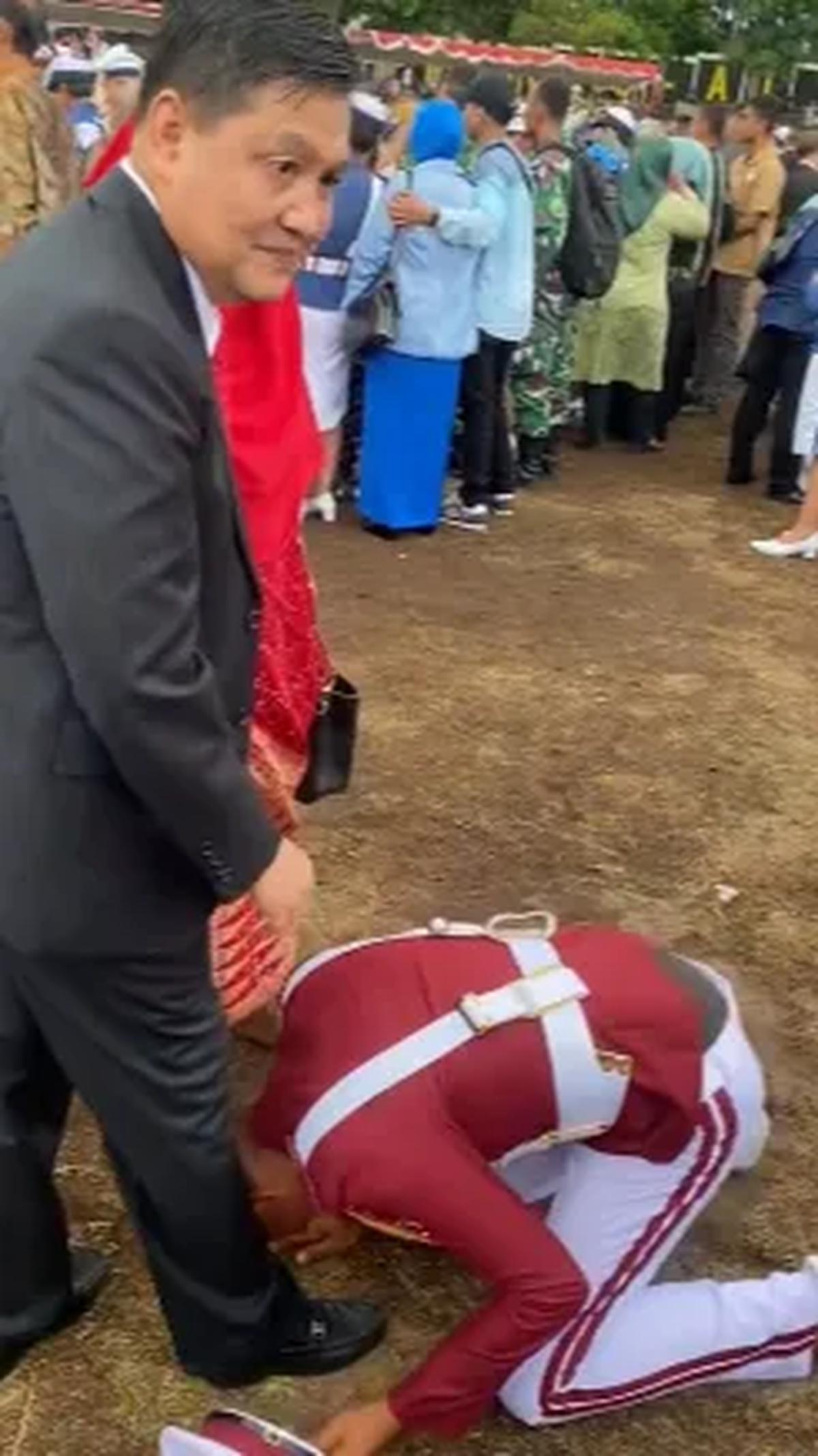 Dengan seragam kebanggaan berwarna merah dan topi putih, Taruna ini langsung sujud di kaki sang ayah.