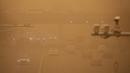 Kendaraan melintas di tengah badai pasir pada jam sibuk pagi hari di Beijing, Senin (15/3/2021). Badan Meteorologi China mengumumkan status kuning dengan menyatakan, badai pasir telah menyebar dari Mongolia ke Provinsi Gansu, Shanxi, dan Hebei, di sekitar Beijing. (AP Photo/Mark Schiefelbein)
