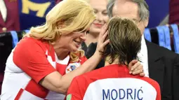 Kolinda Grabar-Kitarovic memberikan semangat kepada Luka Modric usai final Piala Dunia 2018 di Luzhniki Stadium, Moskow, Rusia, (15/7/2018). Meski Kroasia kalah Kolinda tetap tersenyum manis. (AP/Martin Meissner)