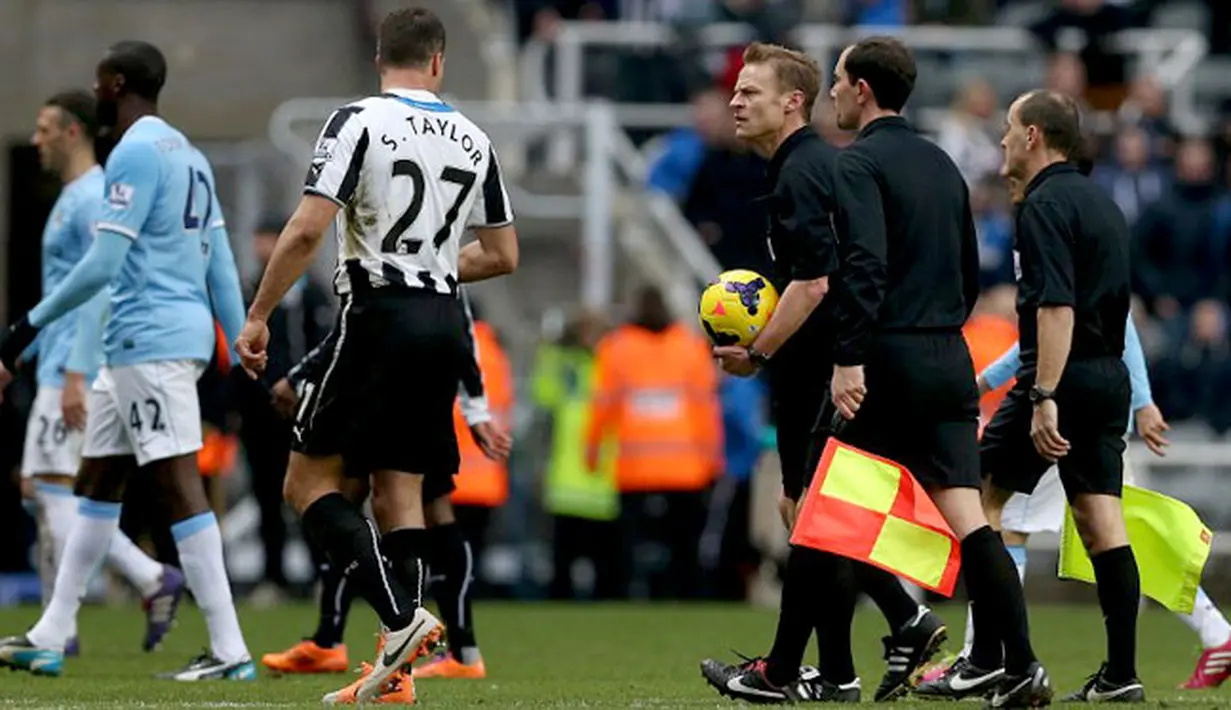 Wasit Mike Jones berbicara dengan bek Newcastle United Mike Williamson pada pertandingan sepak bola Liga Inggris antara Newcastle United vs Manchester City di St James 'Park, Newcastle upon Tyne (12/01/14). (AFP/Ian Macnicol)