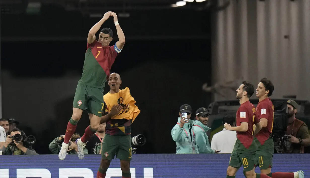 Penyerang Portugal Cristiano Ronaldo berselebrasi setelah mencetak gol dari titik penalti ke gawang Ghana pada duel grup H Piala Dunia 2022 di stadion 974, Kamis (24/11/2022). Pemain yang sudah berusia 37 tahun itu terlihat semringah seusai mencetak gol. Selebrasi khasnya sudah kembali.  (AP Photo/Hassan Ammar)