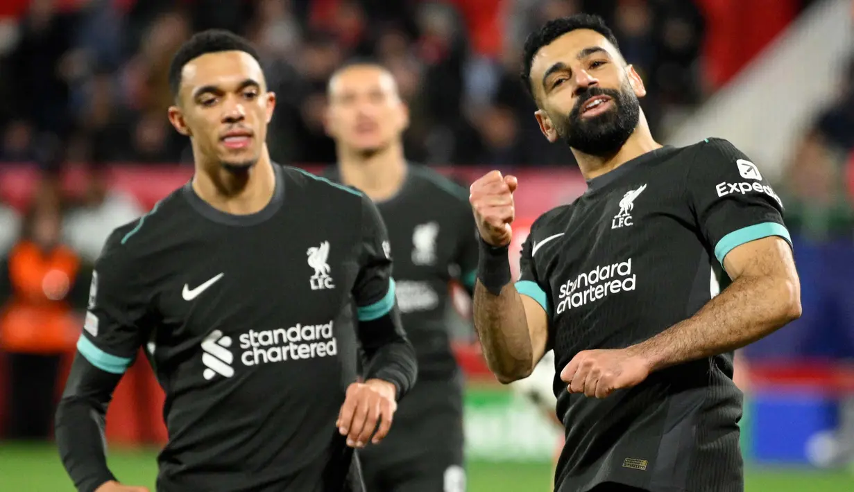 Kemenangan atas Girona semakin mengukuhkan posisi Liverpool di puncak klasemen Liga Champions 2024/2025 dengan hasil sempurna 18 poin dari enam laga. (Josep LAGO/AFP)