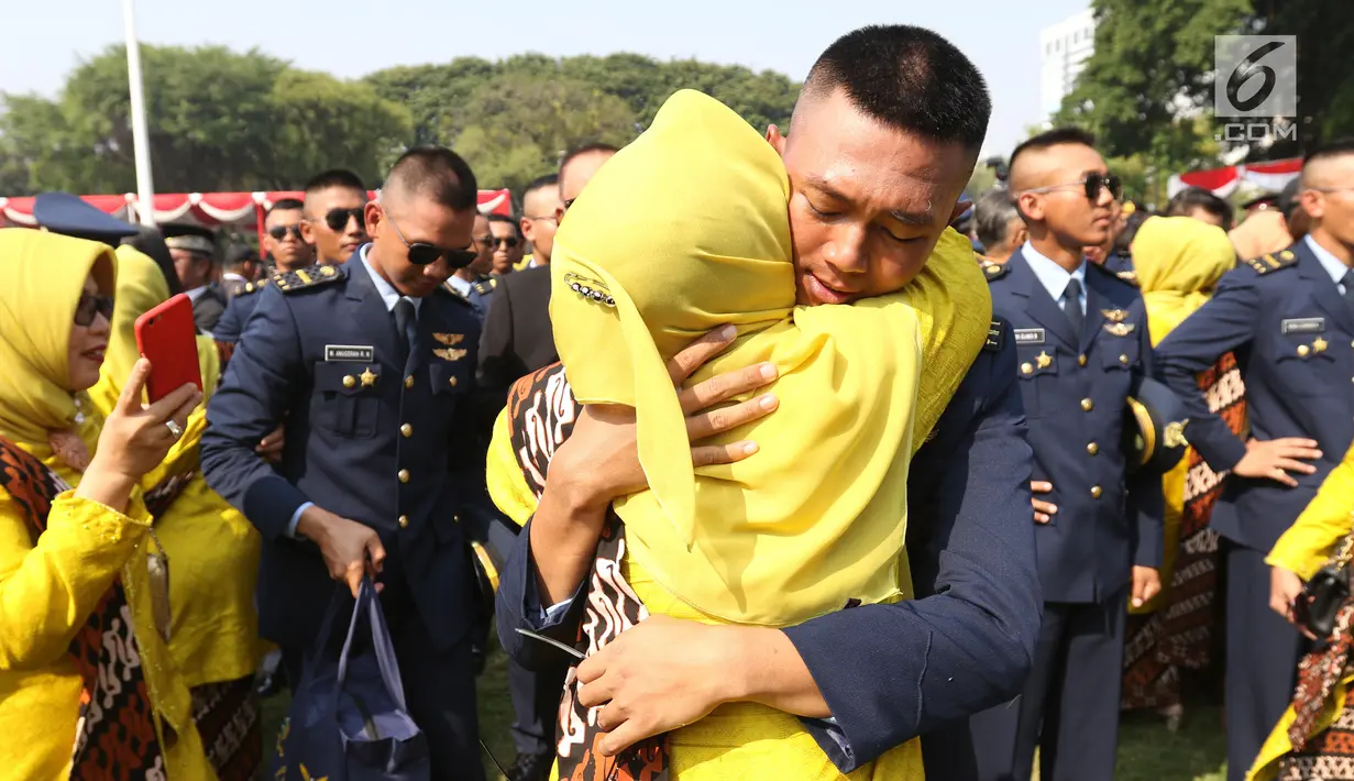 Perwira TNI-Polri menangis sambil memeluk orangtuanya usai dilantik Presiden Joko Widodo atau Jokowi di halaman Istana Merdeka, Jakarta Pusat, Selasa (16/7/2019). Jokowi melantik 781 perwira TNI-Polri di Istana Merdeka. (Liputan6.com/Angga Yuniar)
