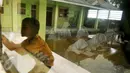 Siswa MI Mansyaul Huda mengikuti pelajaran di kelas yang terkena dampak abrasi pantai Muara Gembong, Bekasi, Selasa, (26/7). Tingkat abrasi yang tinggi menyebabkan sejumlah rumah dan sekolah terkikis dan terendam air laut. (Liputan6.com/Gempur M Surya)