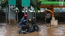 Pengendara motor menepikan kendaraannya saat banjir merendam Jalan Lapangan Banteng Utara, Jakarta, Kamis (15/2). Hujan deras dan buruknya drainase menyebabkan kawasan itu banjir hingga setinggi lutut orang dewasa. (Liputan6.com/Immanuel Antonius)