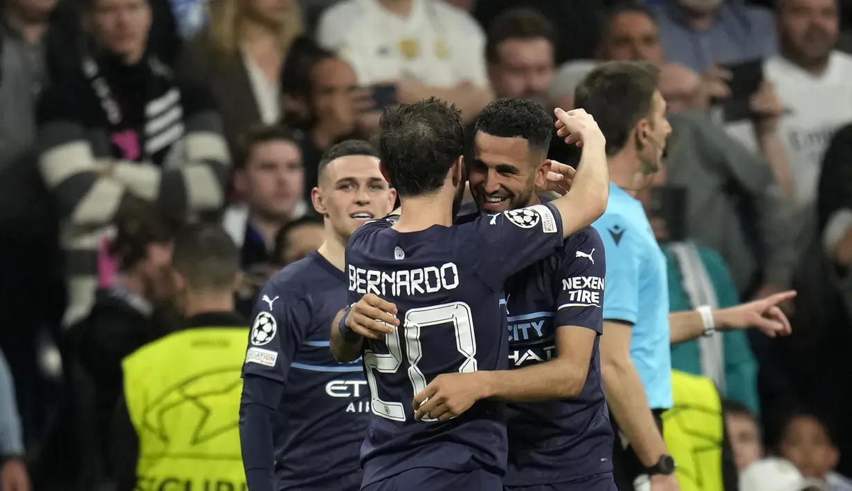 <p>Penyerang Manchester City, Riyad Mahrez (kanan) berselebrasi dengan rekan setimnya usai mencetak gol ke gawang Real Madrid pada pertandingan leg kedua semifinal Liga Champions di stadion Santiago Bernabeu, Spanyol, Kamis (5/5/2022). Madrid menang atas City 3-1 dan lolos ke babak final dengan agregat, 6-5, atas The Citizens. (AP Foto/Manu Fernandez)</p>