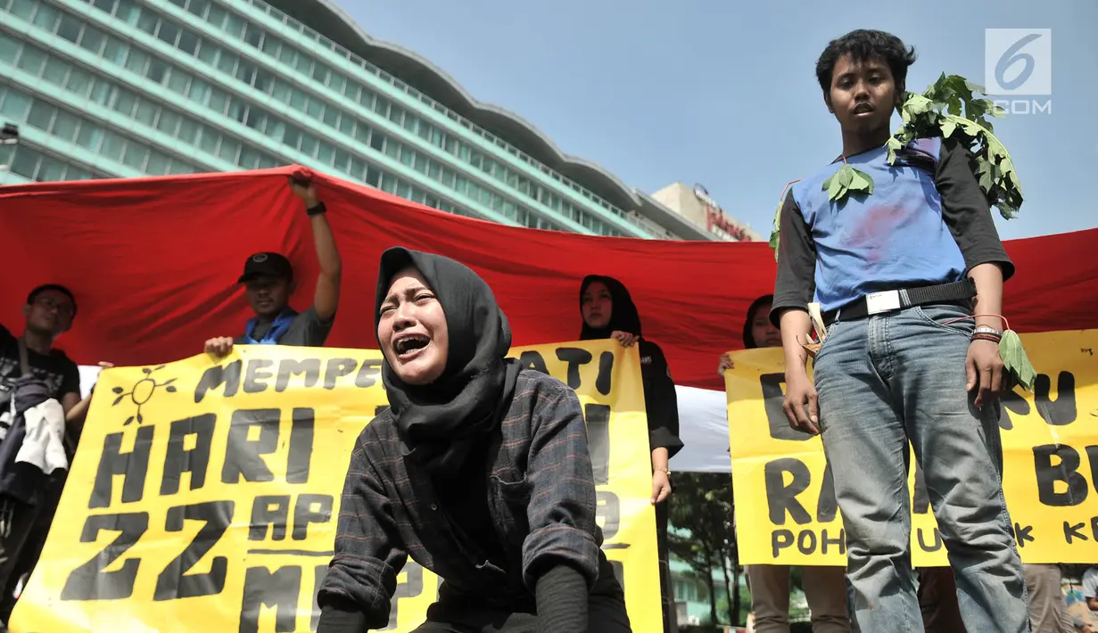 Komunitas Mahasiswa Pecinta Alam (Mapala) se-Jabodetabeka menggelar aksi teatrikan penebangan pohon saat memperingati Hari Bumi di CFD Bundaran HI, Jakarta, Minggu (21/4). Aksi ini untuk memperingati Hari Bumi yang jatuh pada 22 April. (merdeka.com/Iqbal Nugroho)