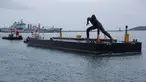 Patung perunggu terbesar di Inggris,  berjudul 'Messenger' tiba dengan tongkang di pesisir pantai Plymouth, Senin (18/3). Patung perunggu tersebut diciptakan oleh seorang pematung berusia 44 tahun bernama Joseph Hillier. (REUTERS/Peter Nicholls)