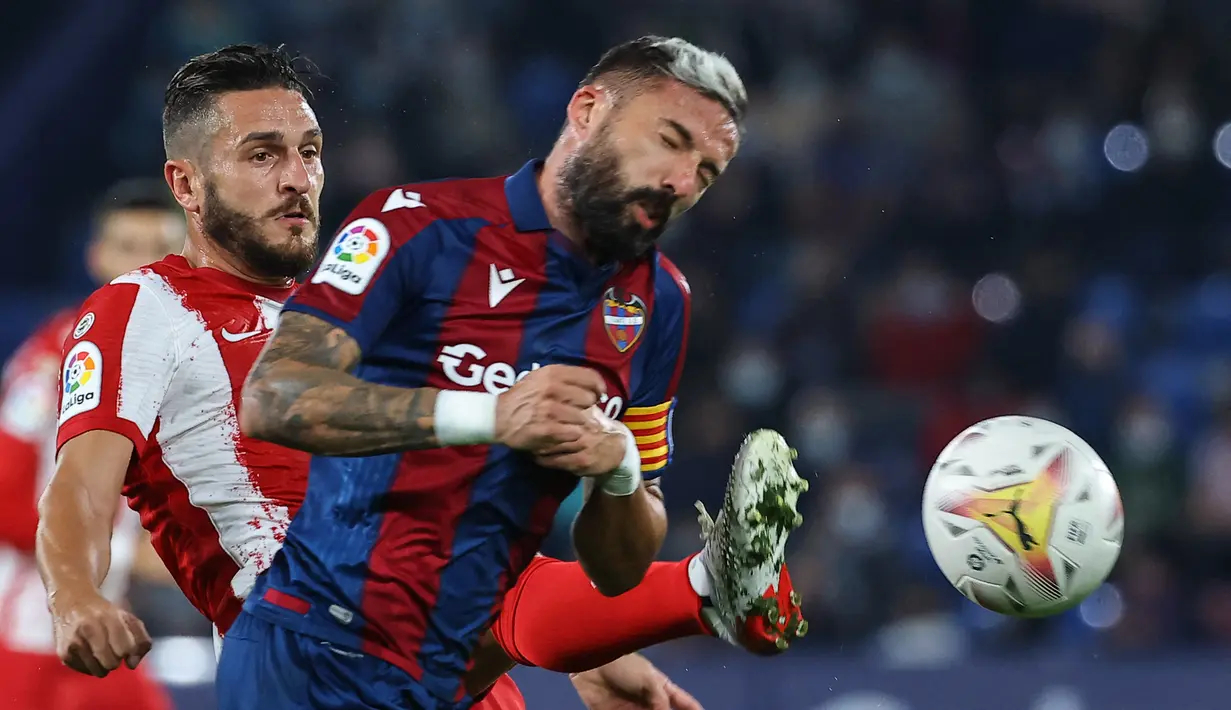 Gelandang Levante, Jose Luis Morales (kanan) berebut bola dengan gelandang Atletico Madrid, Koke selama pertandingan La Liga Spanyol di stadion Ciutat de Valencia di Valencia (29/10/2021). Sementara Levante masih tertahan di zona degradasi, tepatnya di posisi 19 dengan 6 poin. (AFP/Jose Jordan)