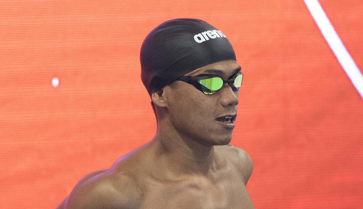 Jendi Panggabean perenang Indonesia saat beraksi pada kualifikasi cabang renang nomor 100 meter gaya bebas putra klasifikasi S9 Asian Para Games 2018 di Stadion Akuatik, Gelora Bung Karno Jakarta, Senin (8/10/2018). (Bola.com/Peksi Cahyo)