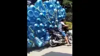 Aksi nekat pengendara sepeda motor membawa galon puluhan galon menggunakan sepeda motor bebek. (Instagram)