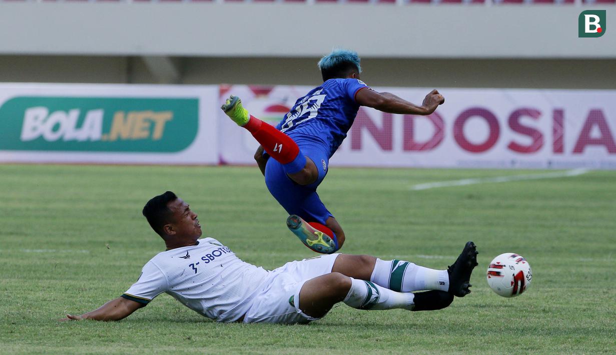Striker Arema FC, Kushedya Hari Yudo, terjatuh saat berebut bola dengan gelandang Persikabo 1973, Wawan Febriyanto dalam laga pembuka Piala Menpora 2021 di Stadion Manahan, Solo, Minggu (21/3/2021). Arema FC bermain Imbang 1-1 dengan Persikabo 1973. (Bola.com/M Iqbal Ichsan)
