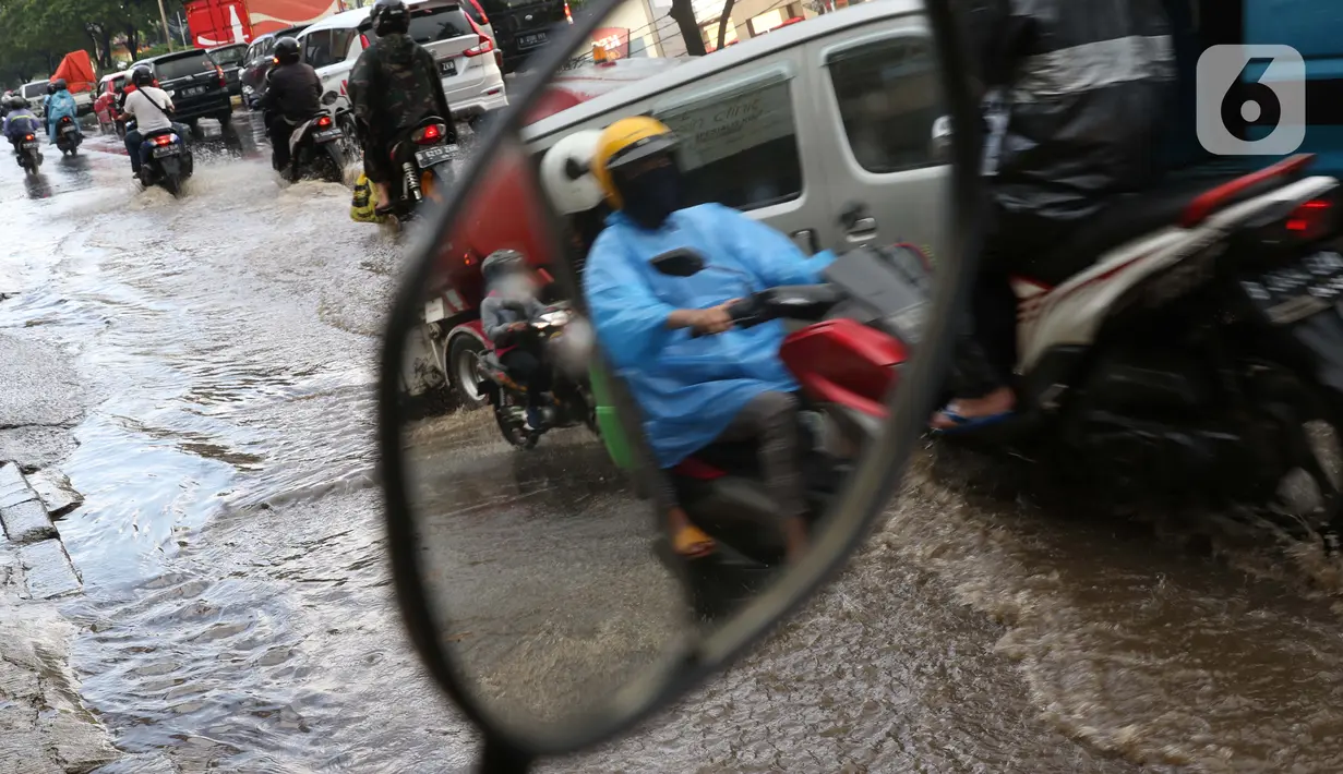 Pengendara melintasi jalan Margonda Raya yang tergenang air, Kota Depok, Jawa Barat, Jumat (29/5/2020). Hujan deras dan tersumbatnya aliran air menyebabkan sebagian ruas jalan Margonda Raya sempat tergenang air serta menyebabkan arus lalu lintas tersendat. (LIputan6.com/Helmi Fithriansyah)