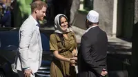 Meghan Markle mengenakan kerudung saat mengunjung masjid tertua di Afrika Selatan bersama Pangeran Harry. (DAVID HARRISON / AFP)