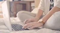 Ilusttasi gunakan laptop di atas kasur
