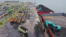 Alat berat (kanan) digunakan untuk memuat batu bara ke truk di Pelabuhan Karya Citra Nusantara (KCN) Marunda, Jakarta, 17 Januari 2022. Indonesia melonggarkan larangan ekspor batu bara. (ADEK BERRY/AFP)