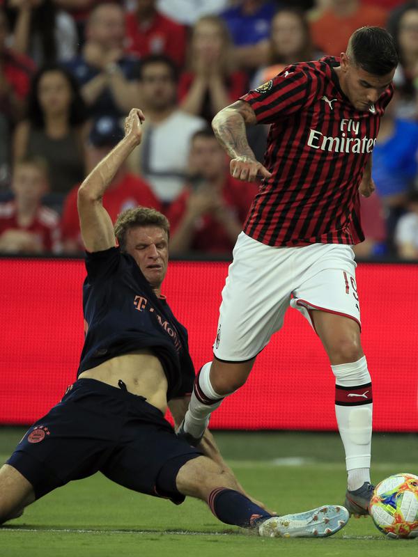 Striker Bayern Munchen, Thomas Muller berusaha merebut bola bek AC Milan, Theo Hernandez selama pertandingan International Champions Cup 2019 di Kansas City, Amerika Serikat (24/7/2019). AC Milan kalah tipis 1-0 atas Munchen berkat gol Leon Goretzka. (AP Photo/Orlin Wagner)