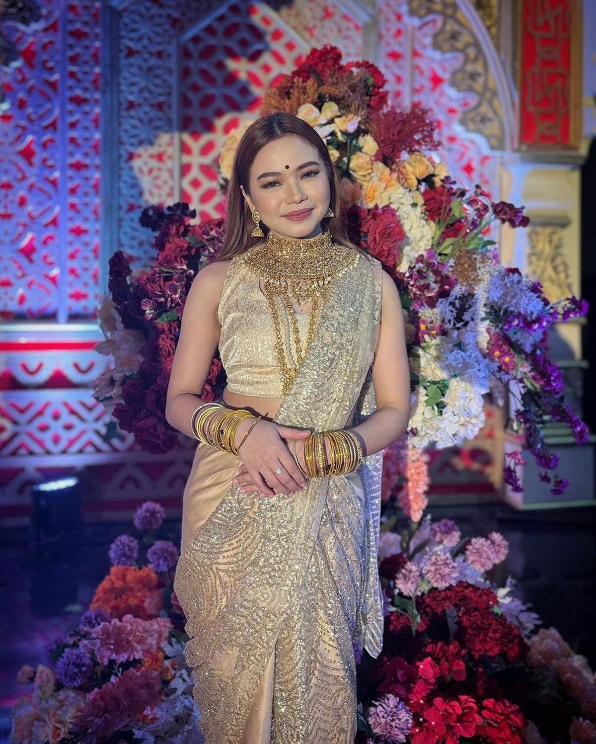 Di pernikahan Putri Isnari, Rara juga tampil dengan outfit warna emas. Ia hadir dalam balutan kain sari beserta aksesoris serba emas.
