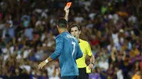 Wasit Ricardo de Burgos memberikan kartu merah kepada Cristiano Ronaldo saat melawan Barcelona  pada laga Supercup Spanyol di Camp Nou stadium, Barcelona, (13/8/2017). Real Madrid menang 3-1. (AP/Manu Fernandez)