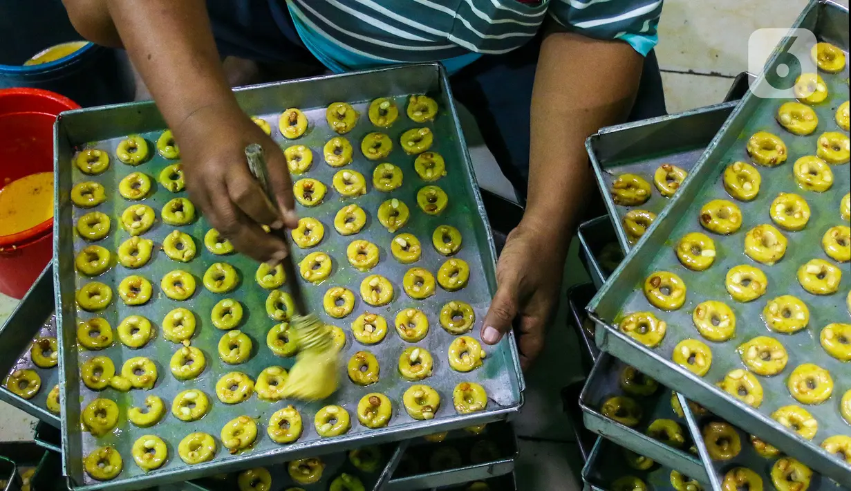 Seorang pekerja membuat kue di industri pembuatan kue kering Pusaka Kwitang, Jakarta, Kamis (30/4/2020). Kue kering yang dijual seharga Rp480 ribu per kaleng itu pada bulan Ramadan tahun ini mengalami penurunan produksi hingga 500 kaleng akibat pandemi COVID-19. (Liputan6.com/Johan Tallo)