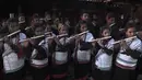Umat Hindu memainkan seruling saat mereka mengambil bagian dalam perayaan pada hari kesepuluh festival Dashain di sebuah kuil di Bhaktapur di pinggiran Kathmandu (15/10/2021). (AFP/Prakash Mathema)
