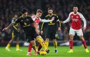 Pemain Manchester United, Lisandro Martinez, melindungi bola dari hadangan pemain Arsenal, Martin Odegaard, dalam pertandingan Liga Inggris di Emirates Stadium, Minggu (25/1/2026) malam WIB. (AP Photo/Kirsty Wigglesworth)