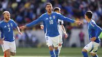 Penyerang Italia, Lorenzo Pellegrini melakukan selebrasi setelah mencetak gol pertama bagi timnya pada laga FIFA Matchday melawan Ekuador di Red Bull Arena di Harrison, New Jersey, pada 24 Maret 2024. (Charly TRIBALLEAU/AFP)