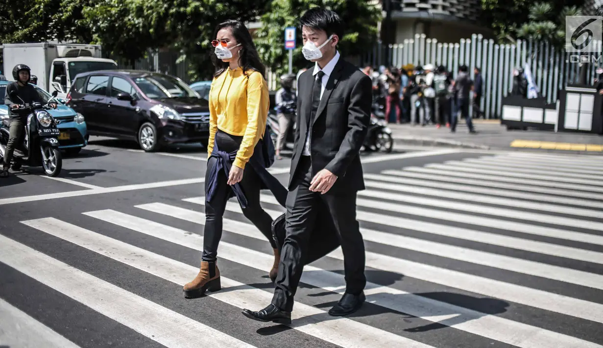 Massa menggelar aksi teatrikal di Pelican crossing di Jakarta, Kamis (20/12). Mereka mengajak pemilih milenial untuk memilih pemimpin yang berorientasi jangka panjang dan berpihak pada energi bersih, adil, dan berkelanjutan. (Liputan6.com/Faizal Fanani)