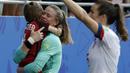 United States goalkeeper Alyssa Naeher holds a young boy as they celebrates at the end of the Women's World Cup round of 16 soccer match between Spain and US at the Stade Auguste-Delaune in Reims, France, Monday, June 24, 2019. US beat Spain 2-1. (AP Photo/Alessandra Tarantino)