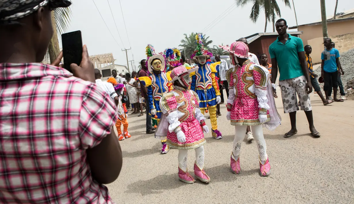 Peserta Winneba Fancy Dress bersiap melakukan parade di Ghana, Senin (2/1). The Fancy Dress festival adalah festival topeng yang diadakan setiap tahun di bulan Januari oleh orang-orang dari Winneba. (AFP PHOTO / Ruth McDowall)