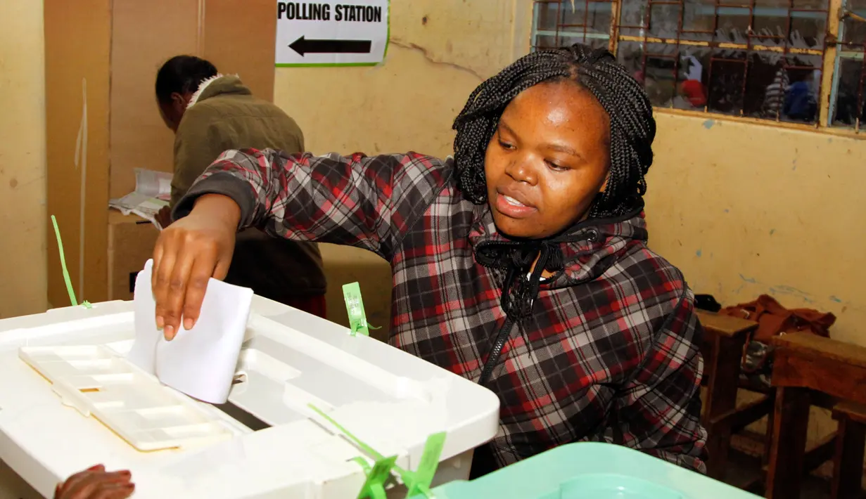 Wanita Kenya memasukkan kertas suara ke dalam kotak usai menggunakan hak pilihnya di sebuah TPS di Nairobi, Selasa (8/8). Negara berpenduduk 50 juta jiwa itu antusias berpartisipasi dalam Pemilihan Umum Presiden baru. (AP Photo/Khalil Senosi)