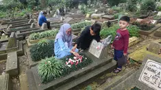 Warga berziarah di makam keluarganya di Tempat Pemakaman Umum (TPU) Dreded, Bogor, Jawa Barat, Minggu (15/2/2026). Jelang bulan suci Ramadan, sejumlah Tempat Pemakaman Umum (TPU) mengalami lonjakan peziarah. (merdeka.com/Arie Basuki)