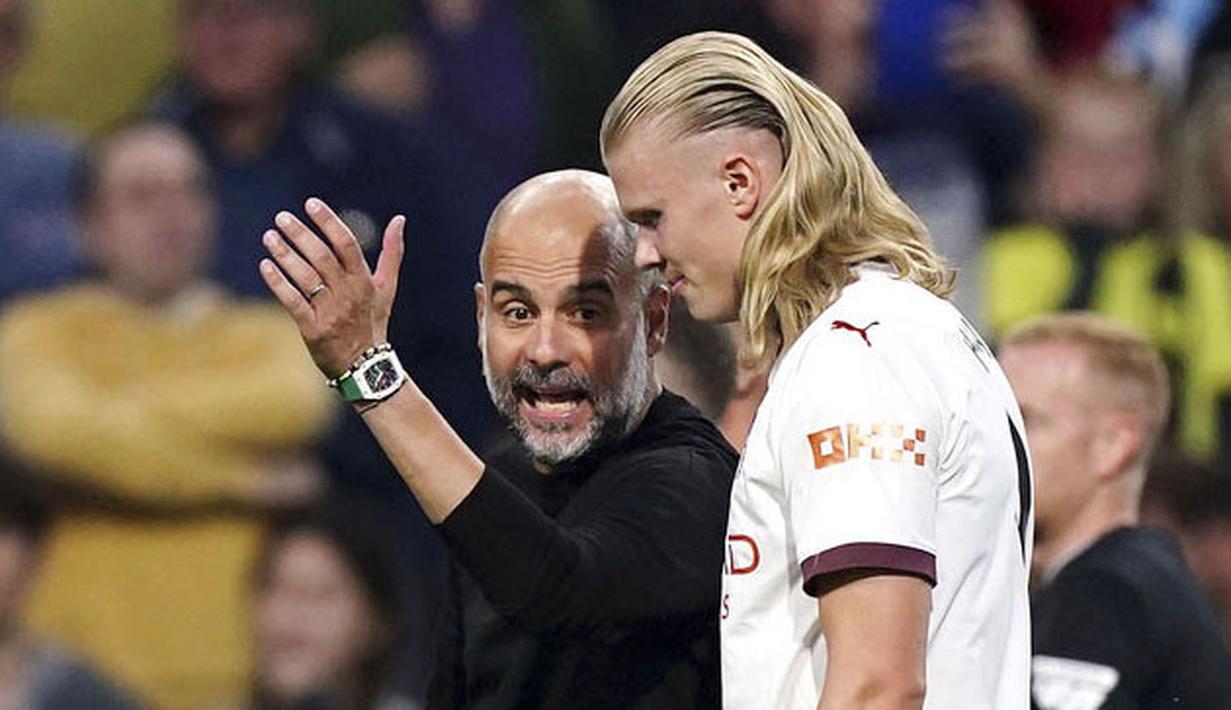 Pelatih Manchester City, Pep Guardiola, tampak memberikan arahan kepada Erling Haaland saat melawan Burnley pada laga pekan perdana Premier League di Stadion Turf Moor, Sabtu (12/8/2023). City menang dengan skor 3-0. (Mike Egerton/PA via AP)
