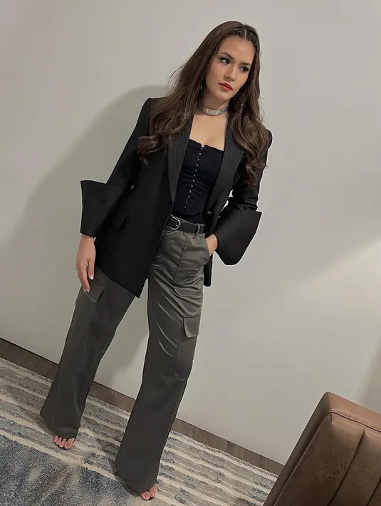 <p>Raisa tak jarang membagikan potret dirinya mengenakan blazer. Dalam foto ini, Raisa tampil mengenakan blazer hitam dengan innerwear hitam yang memiliki detail kancing di bagian depan. Raisa juga memadukan penampilannya secara kasual dengan cargo pants berwarna abu-abu tua. Foto: Instagram.</p>