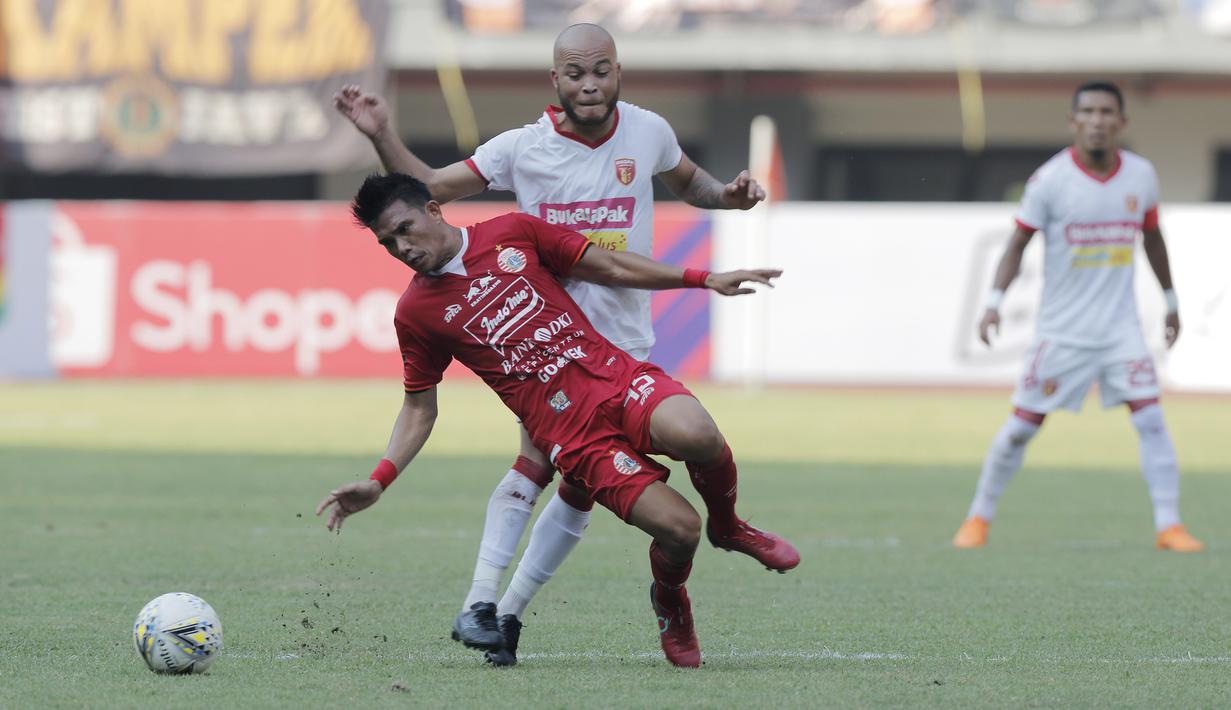 Gelandang Persija Jakarta, Sandi Sute, terjatuh saat berebut bola dengan pemain Perseru Badak Lampung, Marquinhos, pada laga Liga 1 2019 di Stadion Patriot, Bekasi, Minggu (1/9). Persija takluk 0-1 dari Badak Lampung. (Bola.com/M Iqbal Ichsan)