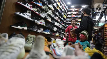 Penjual melayani calon konsumen sepatu impor dari Vietnam dan China di salah satu toko sepatu di Jakarta, Selasa (1/9/2020). Kementerian Perdagangan memperketat prosedur impor produk alas kaki dan barang konsumsi lainnya melalui Peraturan Menteri Perdagangan No. 68/2020. (Liputan6.com/Faizal Fanani)