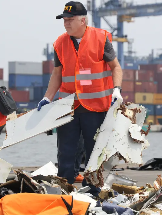 Petugas KNKT memisahkan serpihan pesawat Lion Air JT 610 dari tumpukan barang temuan di Pelabuhan JICT 2, Jakarta, Kamis (1/11). Pemisahan dilakukan untuk pengecekan dan identifikasi. (Liputan6.com/Helmi Fithriansyah)