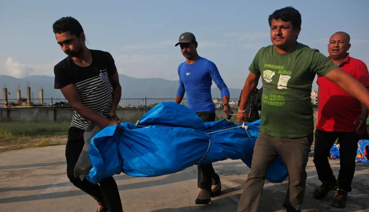 Petugas menggotong jasad pendaki India, Ravi Kumar (27), menuju ambulan setibanya di ibu kota Nepal, Minggu (28/5). Ravi tewas pada bulan ini setelah mencapai puncak gunung Everest dan kemudian terpisah dari pemandunya. (AP Photo/Niranjan Shrestha)