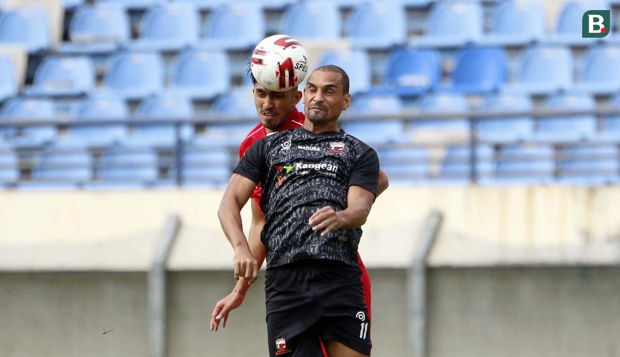 Striker Madura United, Bruno Da Silva Lopes (depan) berduel udara dengan pemain Persik Kediri dalam laga Grup C Piala Menpora 2021 di Stadion Si Jalak Harupat, Bandung, Sabtu (3/4/2021). (Bola.com/Ikhwan Yanuar)