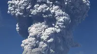 Gunung Sinabung yang mengeluarkan abu tebal terlihat dari kota Berastagi di Sumatera Utara (19/2). Gunung Sinabung kembali menyemburkan abu vulkanik tebal dengan tinggi kolom 5.000 meter. (AFP Photo/Anto Sembiring)