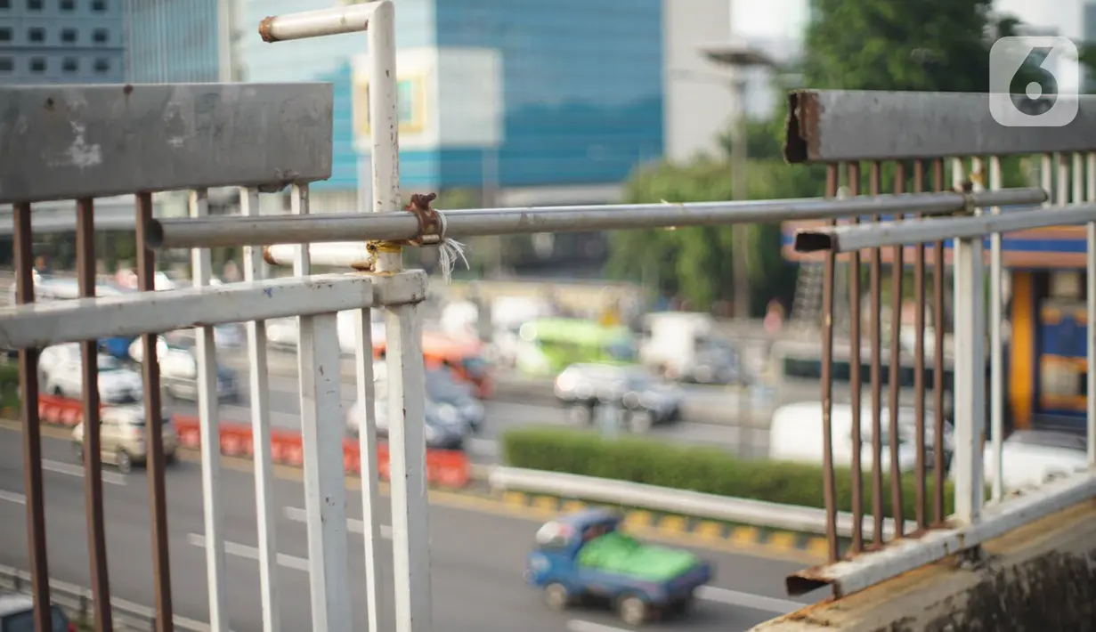 Kondisi pagar JPO yang melintang di atas jalan tol dalam kota dan Jalan Gatot Soebroto di Mampang, Jakarta, Selasa (4/2/2020). Kurangnya perawatan menyebabkan kondisi pagar JPO tersebut banyak yang berkarat sehingga berpotensi membahayakan pejalan kaki yang melintas. (Liputan6.com/Immanuel Antonius)