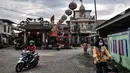 Warga melintas di depan Klenteng Tjong Tek Bio, Kampung Tehyan, Tangerang, Banten, Selasa (9/2/2021). Kehidupan masyarakat Cina Benteng di Tangerang diawali dari berlabuhnya nenek moyang mereka di Teluk Naga pada 1407 yang dipimpin oleh Chen Ci Lung. (merdeka.com/Iqbal S. Nugroho)