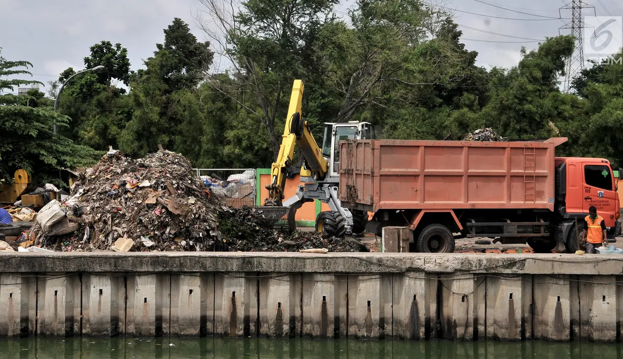 Alat berat mengangkut sampah di area proyek Fasilitas Pengolahan Sampah Terpadu atau Intermediate Treatment Facility (ITF) Sunter, Jakarta, Selasa (12/2). ITF Sunter akan memiliki kapasitas hingga 2.200 ton sampah per hari. (Merdeka.com/Iqbal Nugroho)