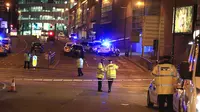 Petugas layanan darurat di lokasi ledakan yang terjadi di arena konser penyanyi Ariana Grande di Manchester, Inggris, Senin (22/5). Setidaknya 19 orang tewas dalam ledakan yang terjadi tepat setelah konser Ariana Grande berakhir. (Peter Byrne/PA via AP)